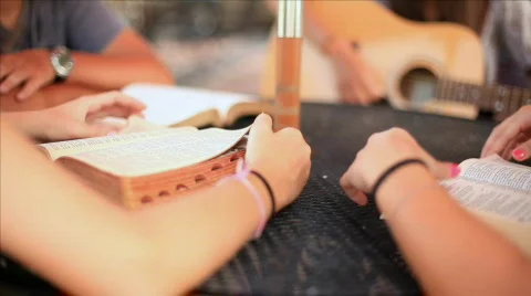Dolly right teens reading bible extreme DOF Stock Footage
