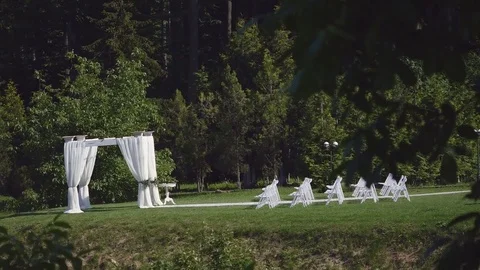 Dolly of rows of chairs at a wedding ceremony from the aisle Stock Footage 78220455