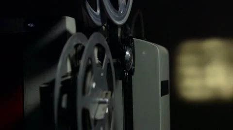 Dolly: Screening movies on vintage film projector Stock Footage