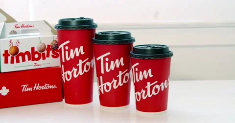 A dolly of Several Tim Hortons coffee cups in different sizes with timbits boxes Vidéo 147414338