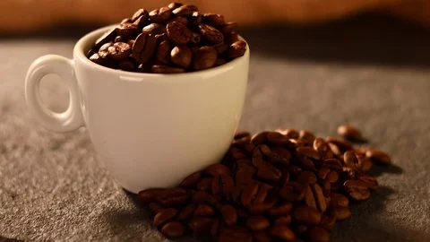 Dolly shoot of cofee beans in espreso cup on concret base Stockbeeldmateriaal 129095039
