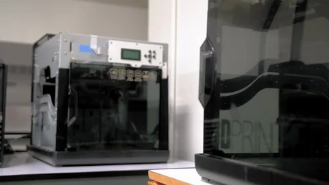 Dolly in shot of a 3D printer on a desk in the office Stock Footage 108965430