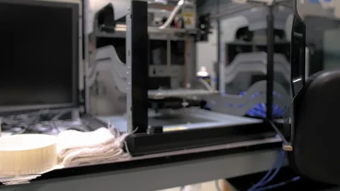 Dolly in shot of a 3D printer on a desk reveals its internal components Stock Footage 108965465