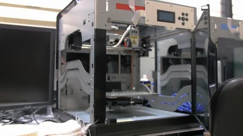Dolly in shot of a 3D printer on a desk reveals its internal components Stock Footage 108965476