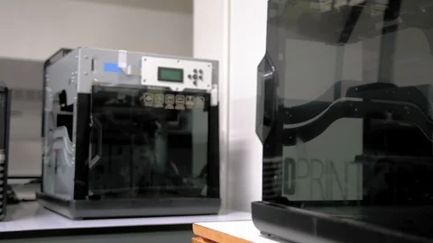 Dolly in shot of a 3D printer on a desk in the office Stock-Footage 108965502