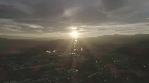 Dolly shot of amazing sun rays over small industrial town in the valley, 4K Stock Footage 73684717