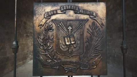 Dolly shot back of copper Coat of arms of the Dominican Republic on closed Stock Footage 274738799