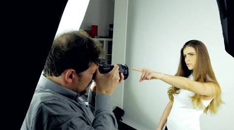 Dolly shot of Backstage of photo session in studio with female model and photogr Stock Footage 61770248