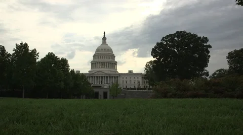 Dolly shot from behind a lamp post reveals US Capitol Building in Washington, DC Stock Footage 47059625
