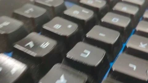 Dolly shot of a black computer keyboard and mouse with back light Stock Footage 160305080