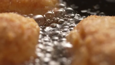 Dolly shot of Breaded Cutlets Sizzle in Frying Pan. Stock Footage 258651210