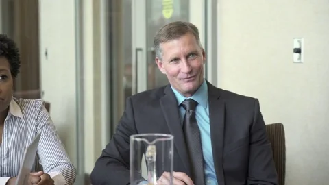 Dolly shot of business people attending presentation in board room Stock Footage