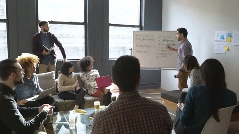 Dolly shot of businessman brainstorming with colleagues in meeting Stock Footage