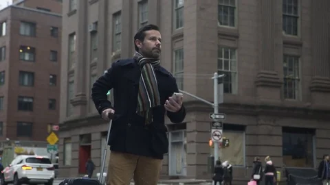 Dolly shot of businessman waiting for taxi Stock Footage