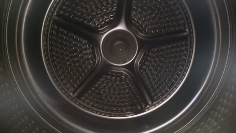 Dolly shot of camera sliding inside old, empty washing machine drum or dryer Stock Footage