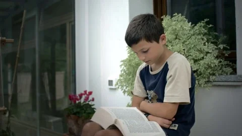 Dolly shot of child reading Stock Footage 78929453