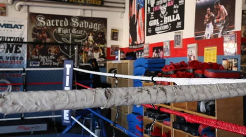 Dolly shot close up of boxing ring ropes and punching bags Stock Footage 47077357