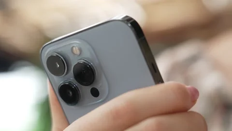 Dolly shot. Close-up macro plan of camera lenses of new Apple iphone 13 Pro Stock Footage 166099867