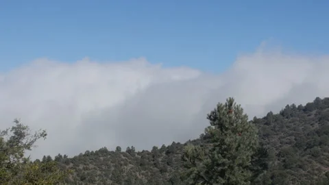 Dolly shot of a cloud rolling in over a mountain 스톡 동영상 142097454