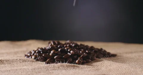 Dolly Shot Of Coffee Beans Falling On Hessian Sack 4K Stock Footage 86084816