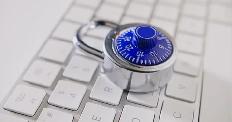 Dolly Shot Of Combination Lock And Computer Keyboard Stock Footage 92365911
