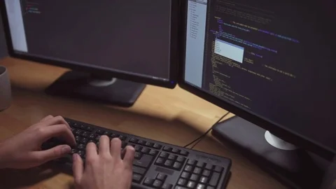 Dolly shot of concentrated software developer coding Stock Footage 75013367