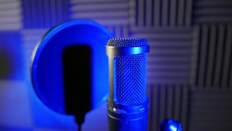 Dolly shot of a condenser capacitor microphone in a voice over podcast Stock Footage 178827166