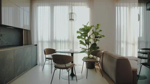 Dolly shot of cozy modern kitchen the table and chairs are by the window Stock Footage 247205037