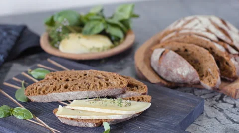 Dolly shot of cut sourdough bread and artisan cheese Stock Footage 63263193