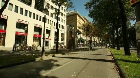 Dolly shot of cyclists ride through the Vienna Boulevard Stock Footage 21249596