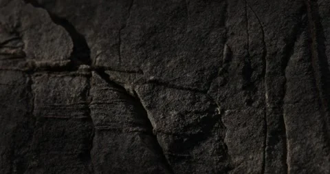 Dolly shot of Dark Rock Surface with Linear Cracks and Textures. Stock Footage 278065785