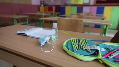 Dolly shot of empty chairs and desks in classroom school preparation in small Stock Footage 256719915
