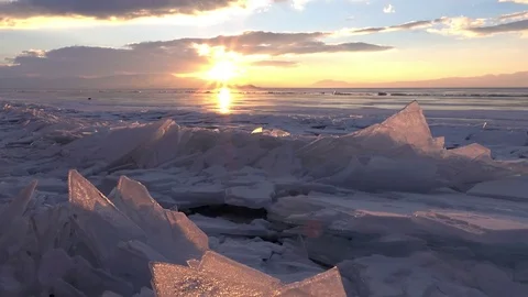 Dolly shot of gorgeous sunset over small icebergs and icicles Stock Footage 73299404