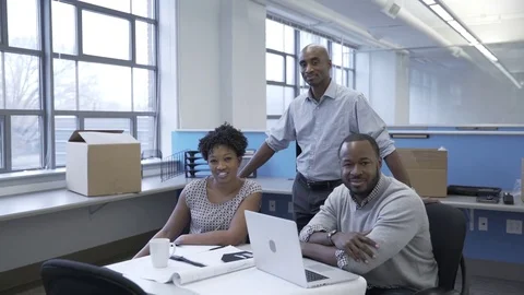 Dolly shot of happy business people in new office Stock Footage