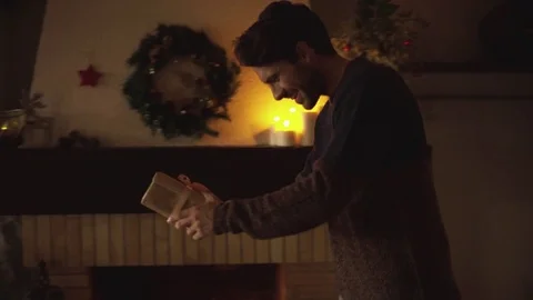 Dolly shot of happy man giving surprise gift to woman during Christmas Stock Footage