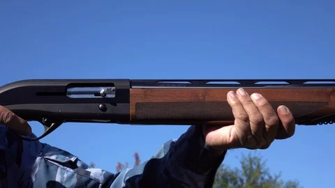 Dolly shot of hunter pointing his gun on a prey Stock Footage 86612927