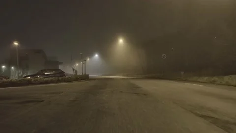 Dolly shot of industrial road on a dark foggy night 4K Stock Footage
