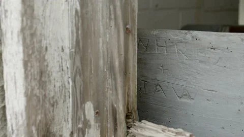 Dolly shot of initials etched in abandoned building Stock Footage 152532435