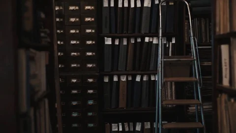 Dolly shot interior of old archive bookshelves with document folders Stock Footage 71926999