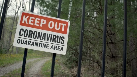 Dolly shot of a Keep Out Coronavirus Quarantine Area sign Stock Footage 128447904