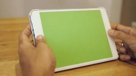 Dolly shot  -A man uses a tablet computer with green screen Stock Footage 65987634