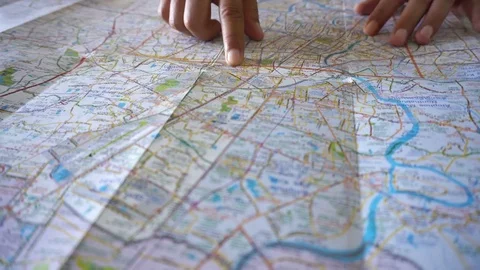 Dolly shot of man's hand drawing on map by finger Stock Footage