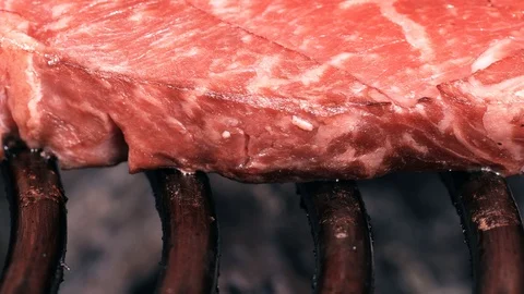 Dolly shot of the marbled beef steak on a grill Видео 96680281