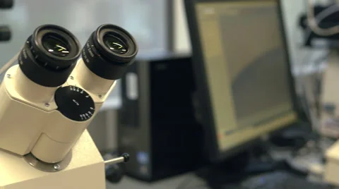 A dolly shot of a medical microscope which is used for artificial insemination Stock Footage 42313987