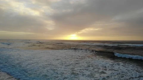 Dolly Shot Medium Height over Surf into Sunset Video stock 145235944