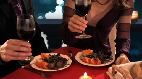 Dolly shot of mid aged couple at dinner toasting Stock Footage 43675943