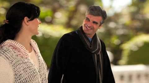 Dolly shot of mid aged couple walking in park Stock Footage 43676526