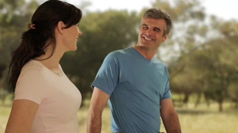 Dolly shot of mid aged couple walking in countryside Video stock 43676540