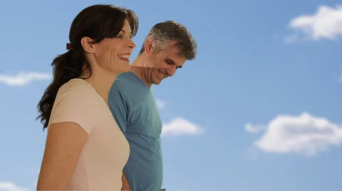 Dolly shot of mid aged couple walking Stock Footage 43676546