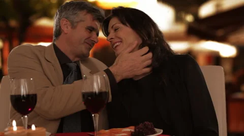 Dolly shot of mid aged couple dining in town Stock Footage 43676731